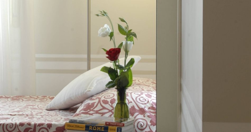 accessible bedroom with a rose beside it