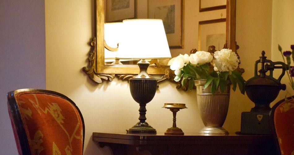 comfy chair beside a table and lamp