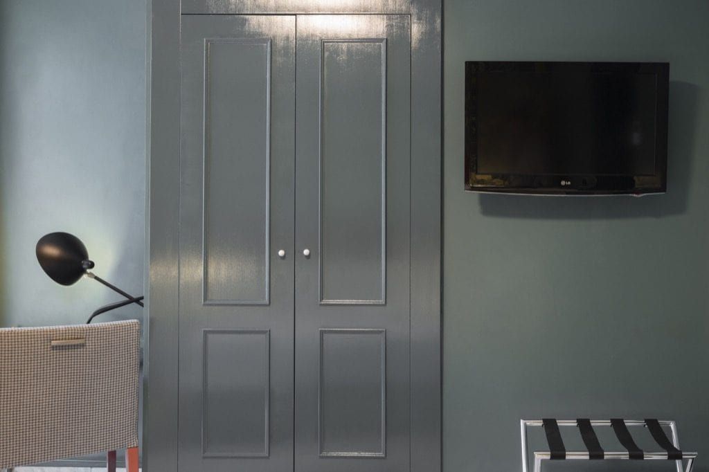 TV and wardrobe among a grey colour pallet