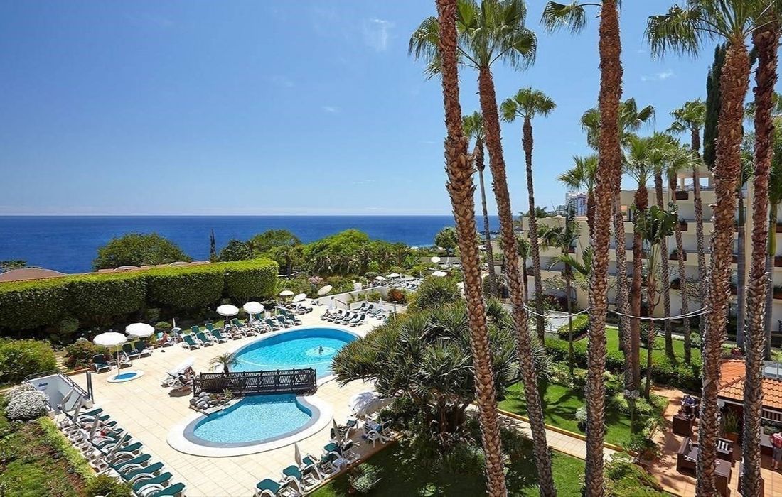 outdoor swimming pool surrounded by sunbeds
