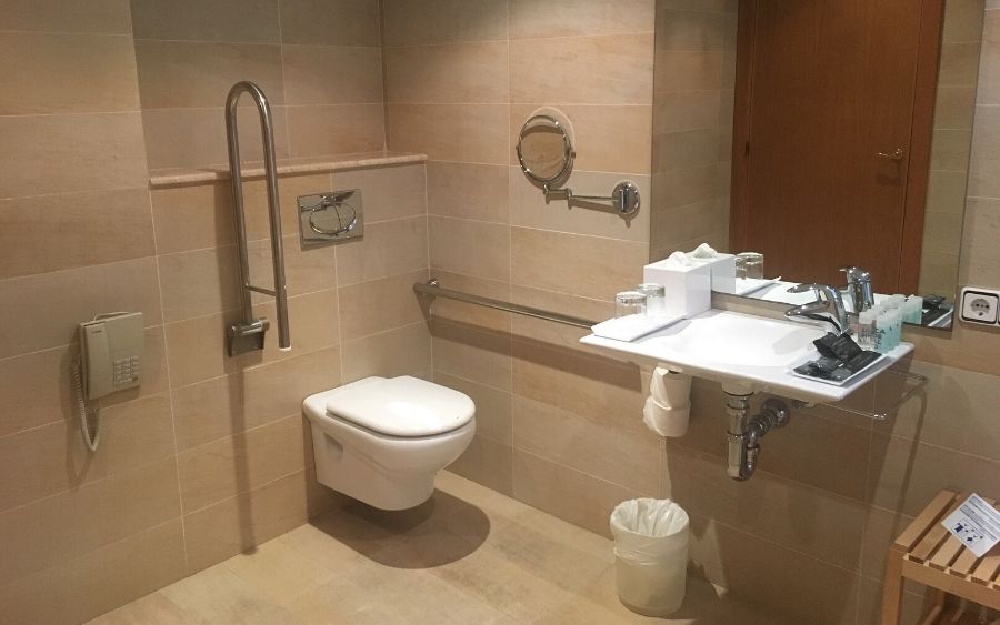 adapted bathroom with grab rails for the toilet
