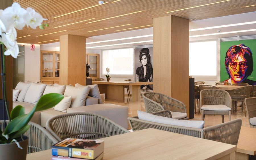 indoor lounge area with a painting of John Lennon in the background