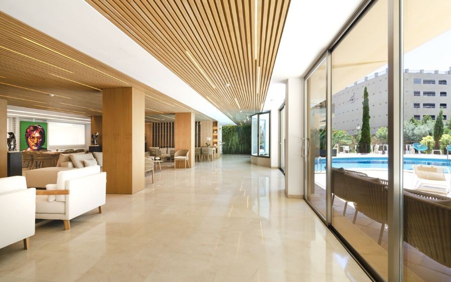 wide hallway leading past the indoor lounge area to the outdoor swimming pool