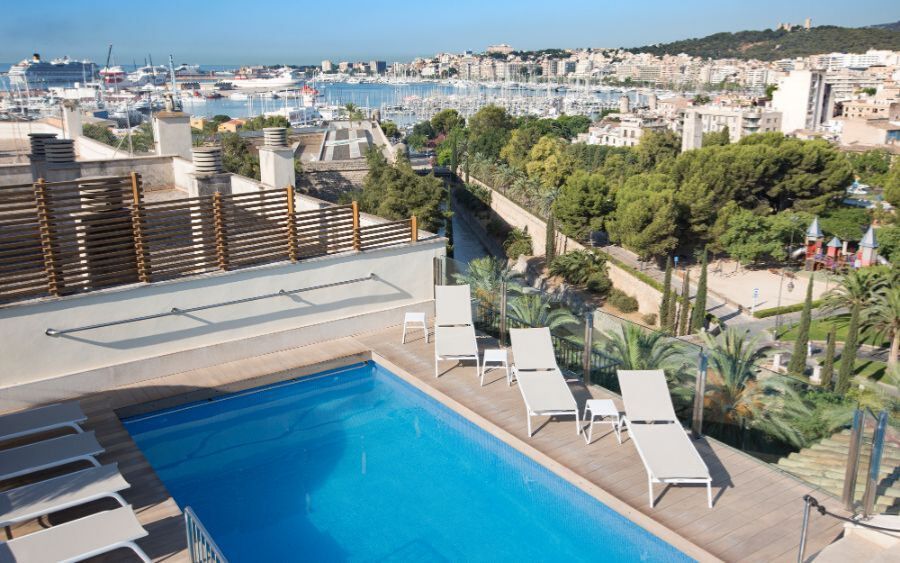 outdoor rooftop swimming pool with a view of the city