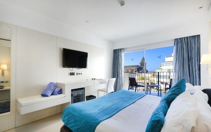 spacious hotel room with a view of the city