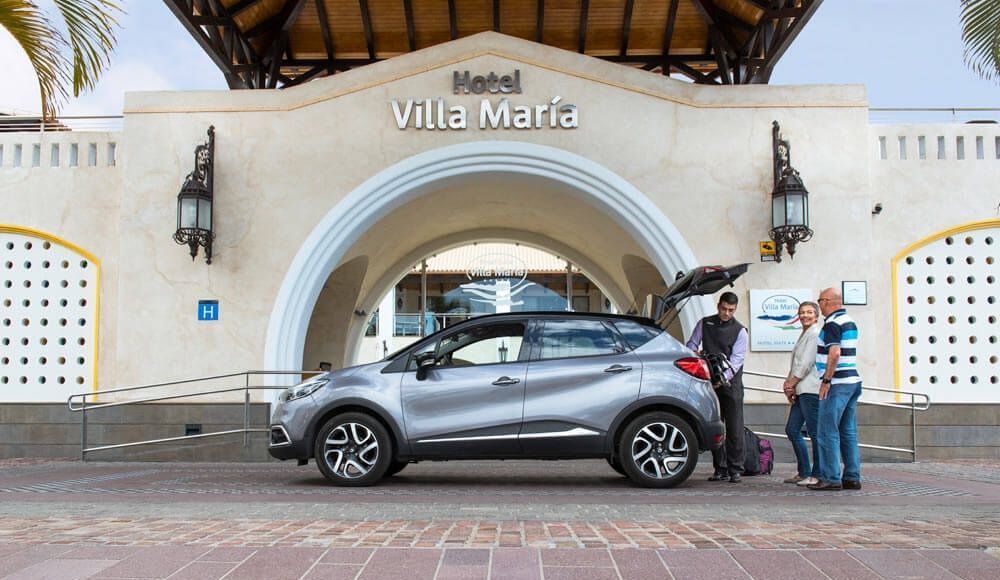 hotel entrance with a bellboy helping guests with their bags