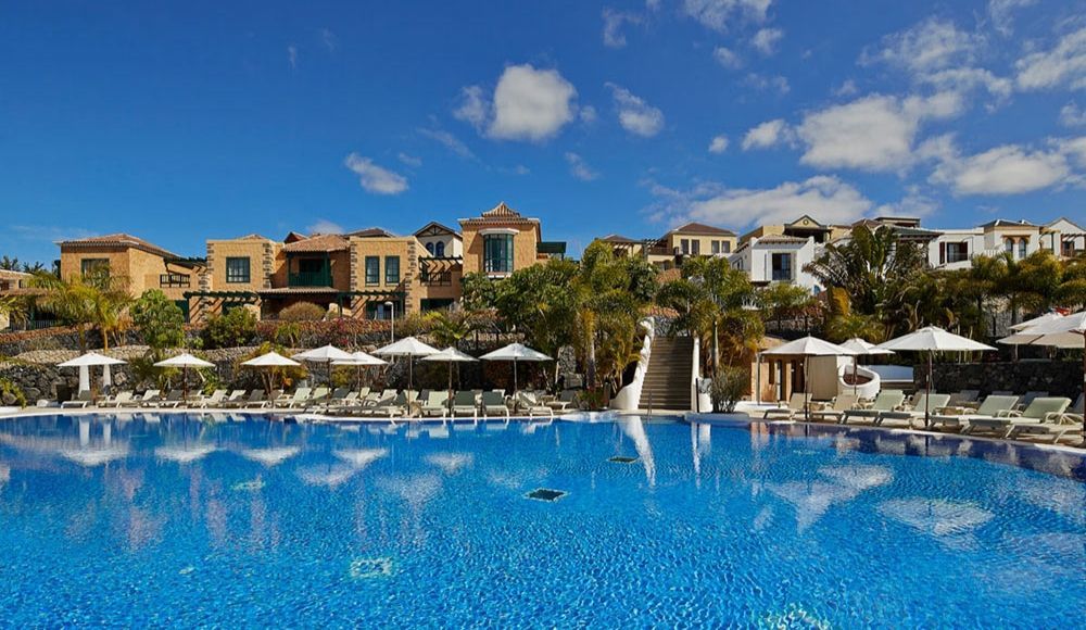 large outdoor swimming pool sitting closer to the hotel