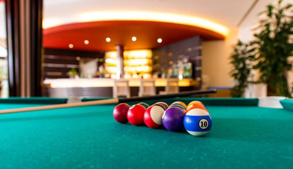 view of the bar in the background with a pool table up front