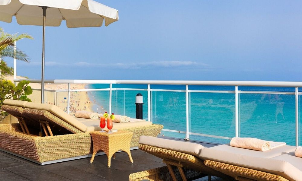 sunbeds overlooking the ocean with cocktails nearby