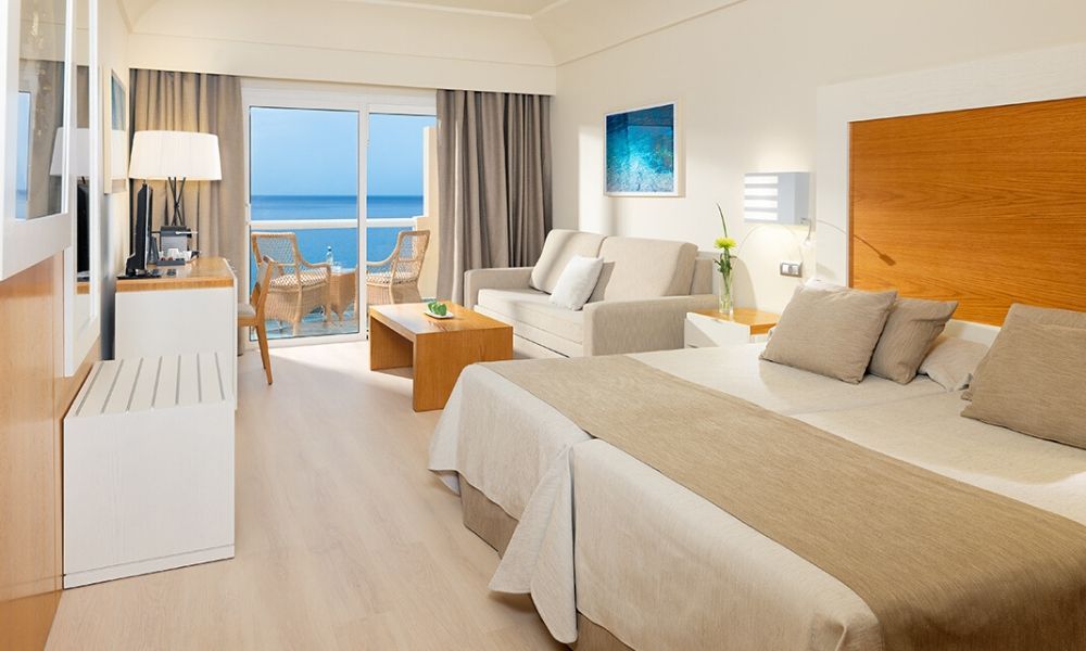 spacious bedroom with a living area