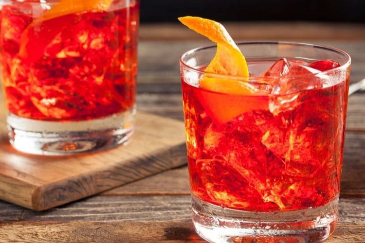 red cocktail drink with a twist