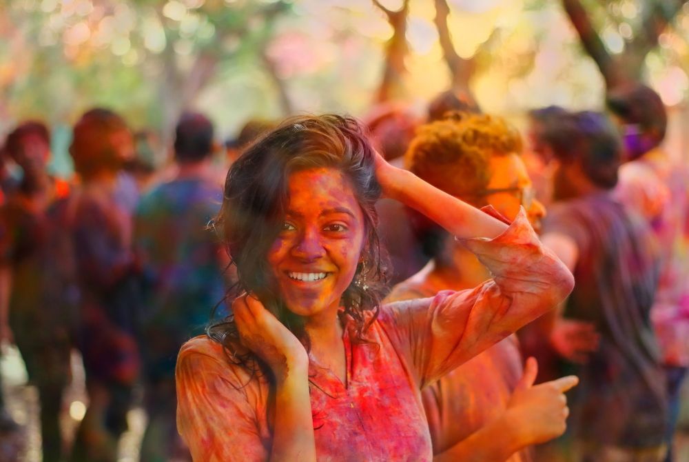 Holi Festival with powdered paint in the air and over everyone