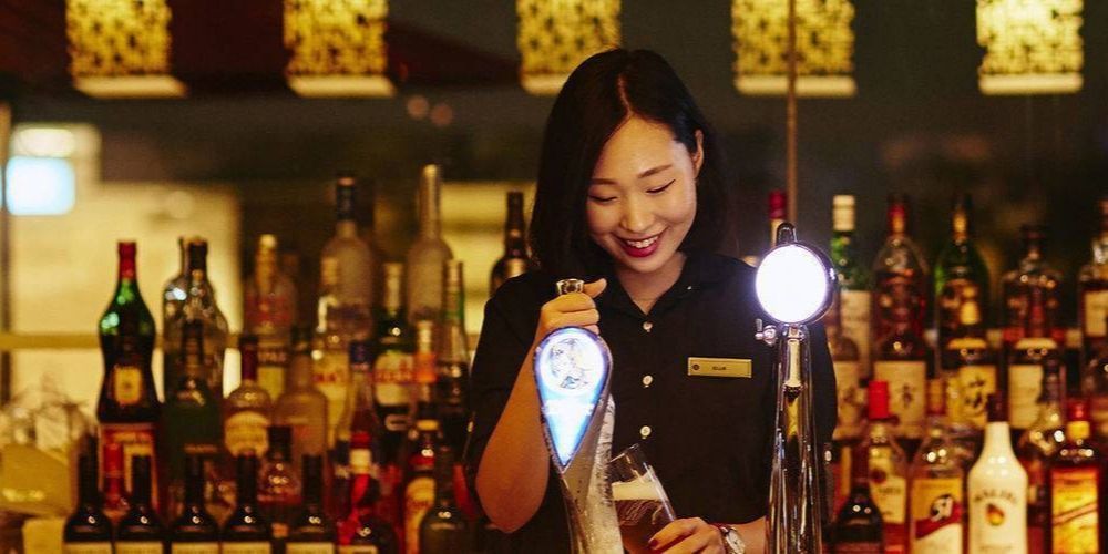 friendly staff member pouring draft beer