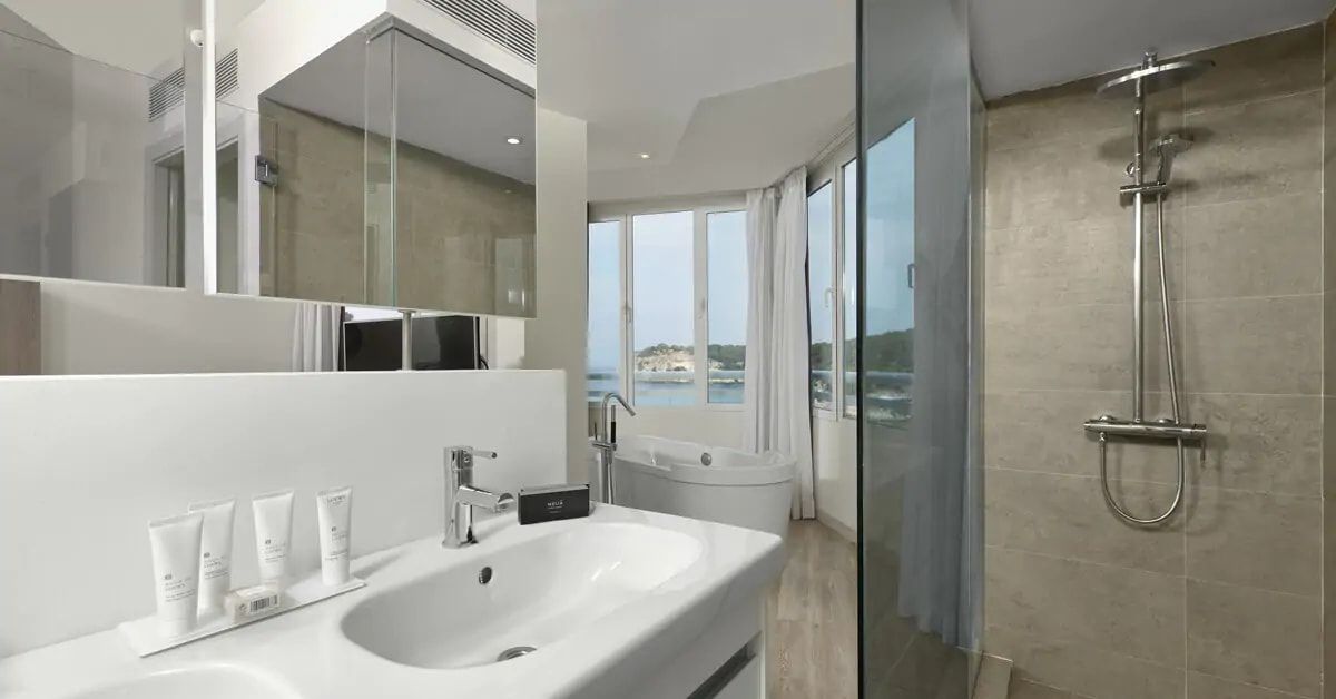 bathroom showing a walk in shower and sink