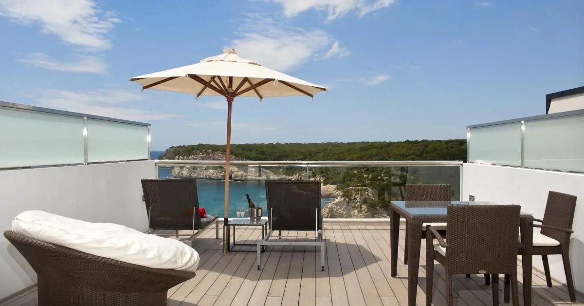 terrace balcony overlooking the ocean with sunbeds