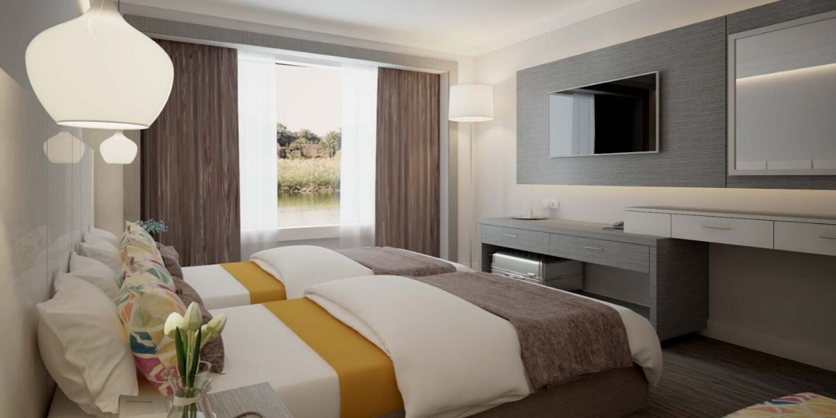 twin beds with a tv and view of the river