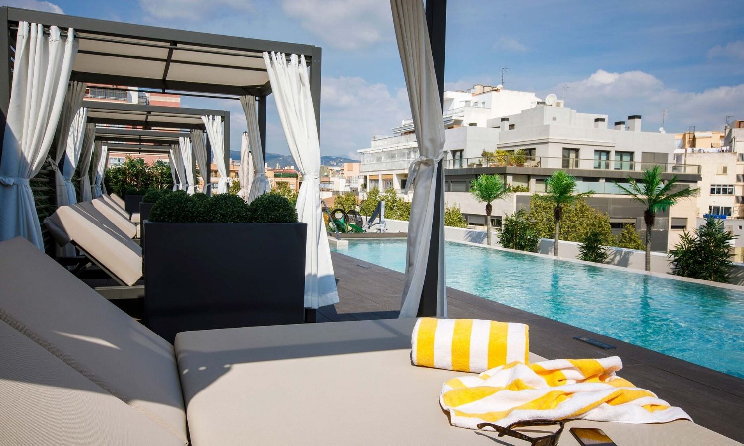 sunbeds surrounding outdoor swimming pool