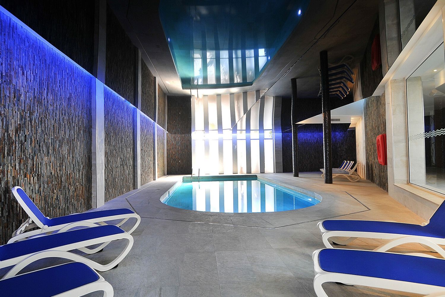indoor swimming pool with sunbeds