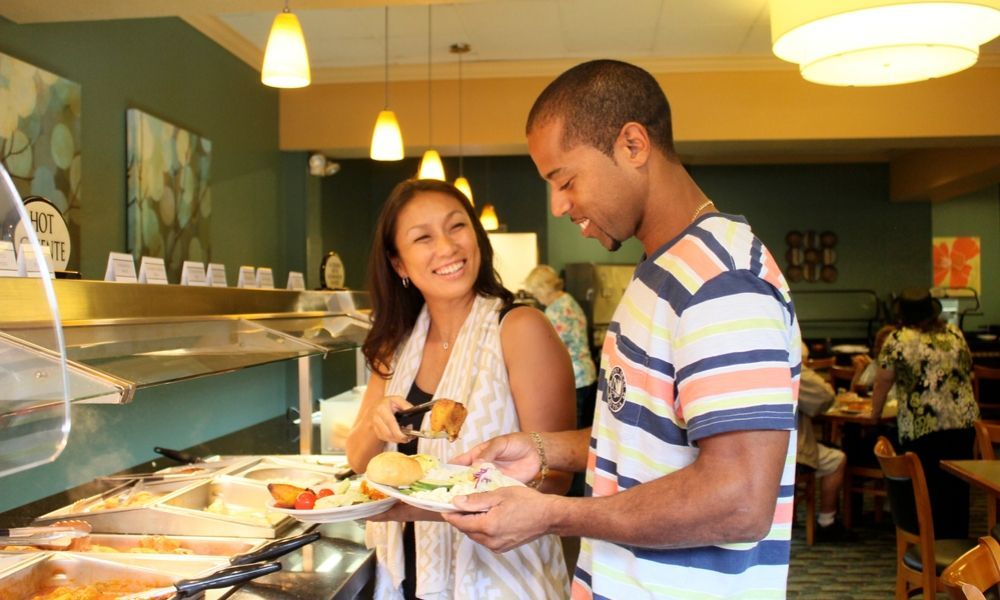 couple picking food from the buffet