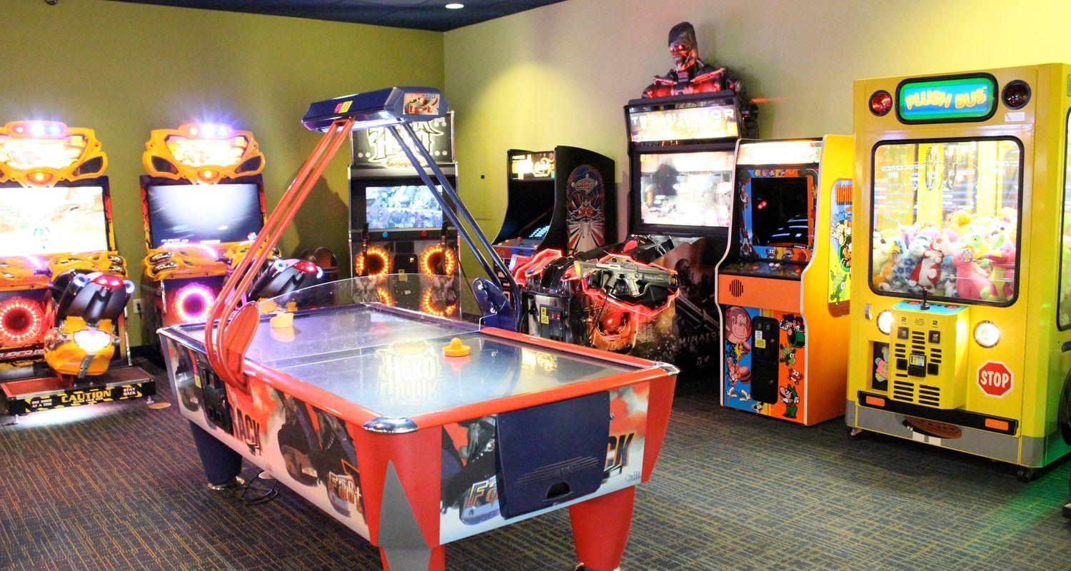 games room with arcade machines and air hockey