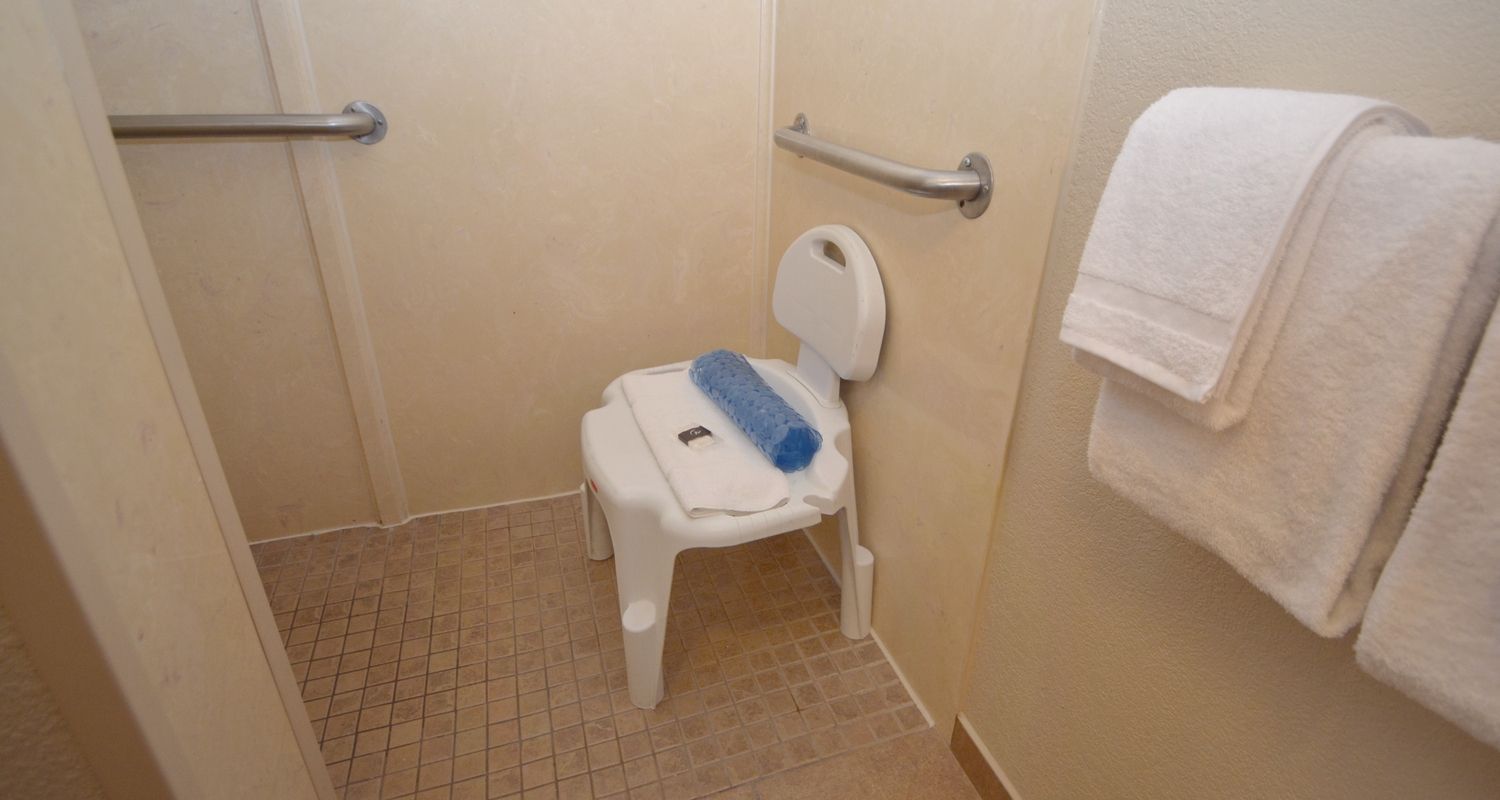 wheel-in shower with a shower chair