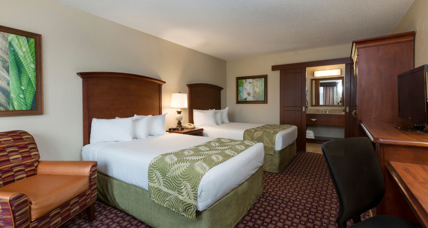 spacious hotel room with two queen beds