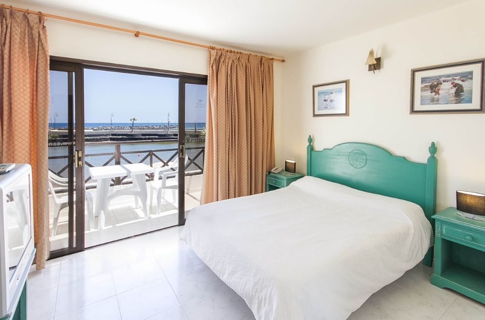 bright hotel room with a balcony terrace and sea view