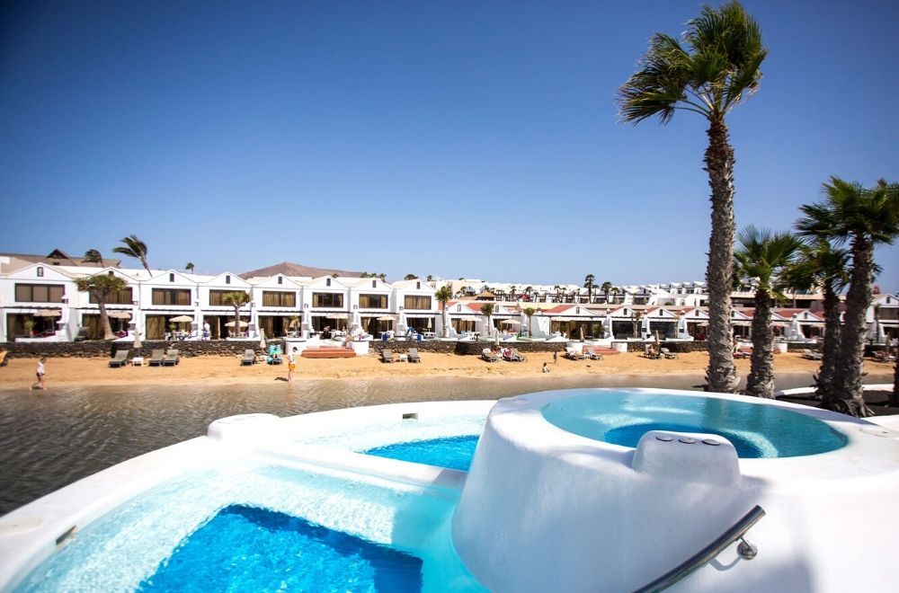 outdoor swimming pool looking toward the hotel and beach