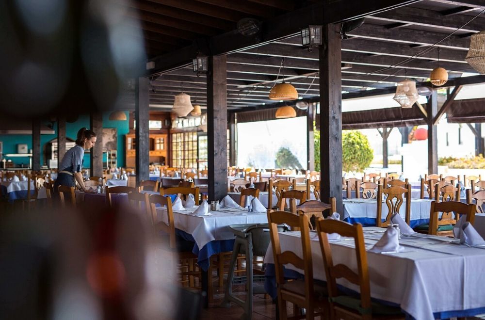 hotel waitress preparing tables for service