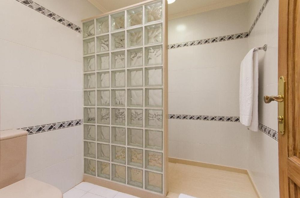 flat floor shower with a small step to enter