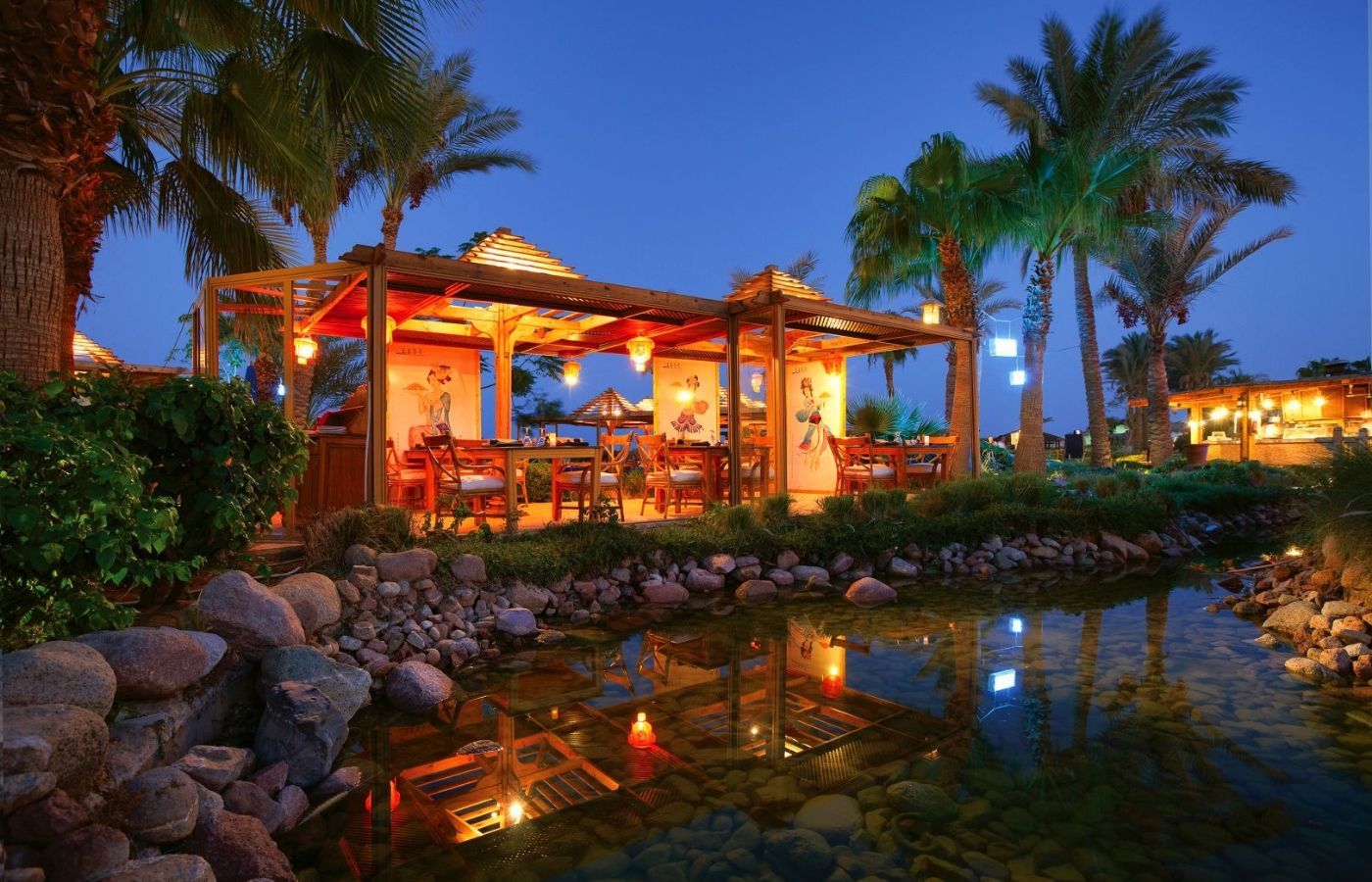 outdoor dining area nearby a tranquil pond