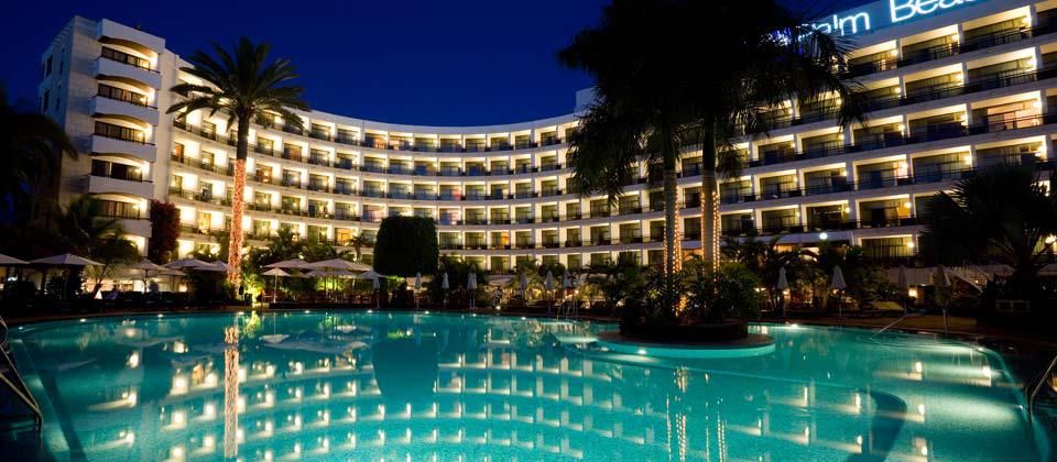 hotel exterior at night with the room lights all turned on