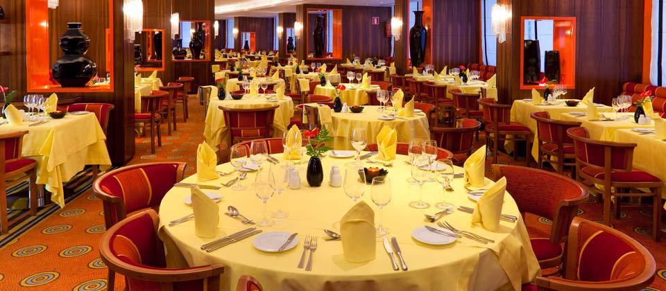 large indoor dining room with vibrant yellow and red decor
