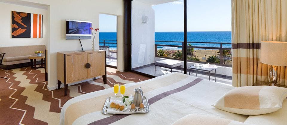 spacious hotel room with a balcony terrace where you can enjoy room service