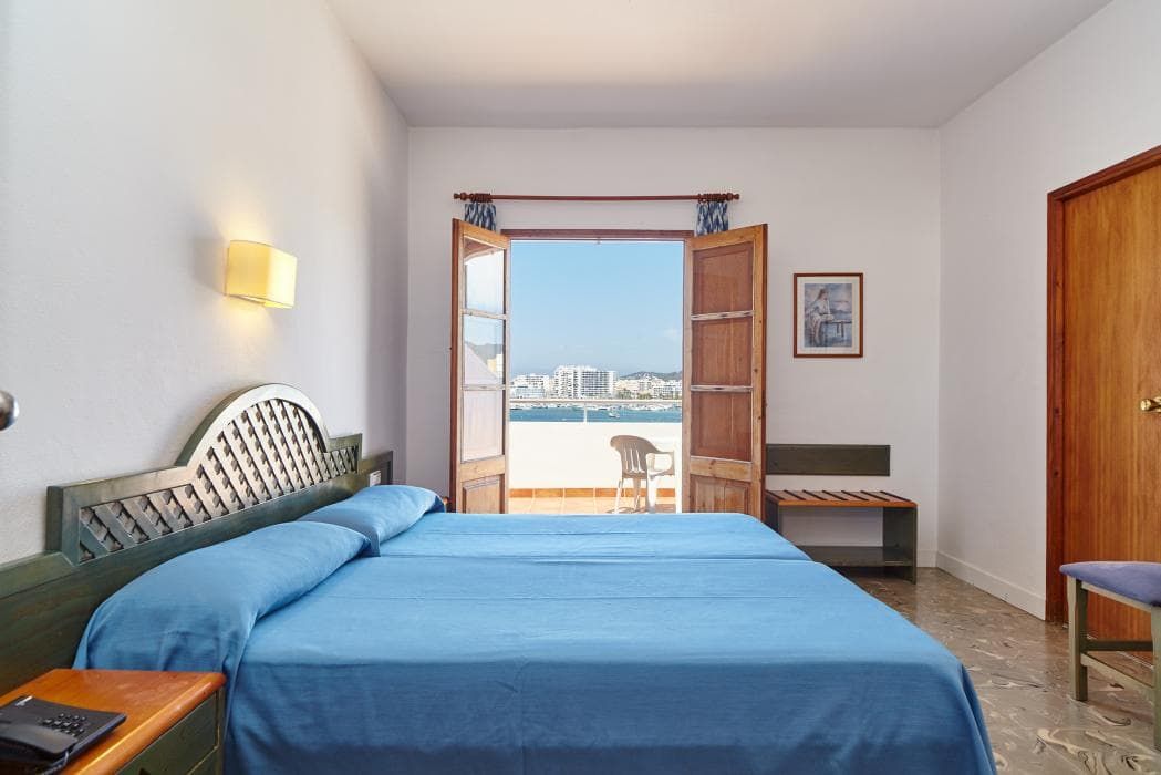 twin beds pushed together with a balcony