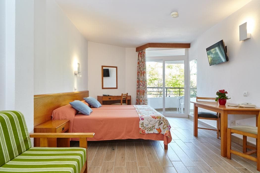 spacious double bedroom with a small balcony