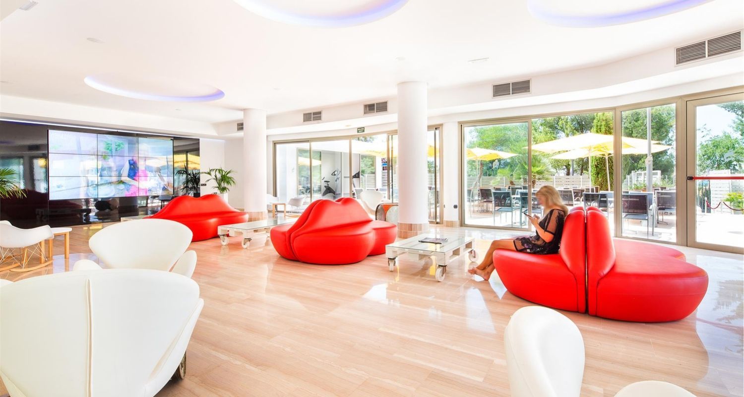 bright bar space with red lip styled chairs