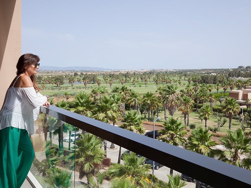 hotel guest admiring the scenic view from the balcony