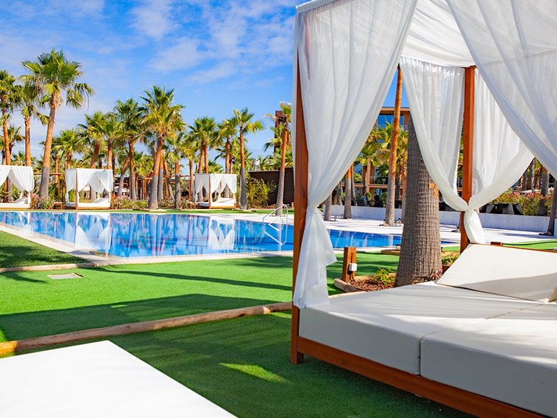 outdoor swimming pool with giant canopy sun beds