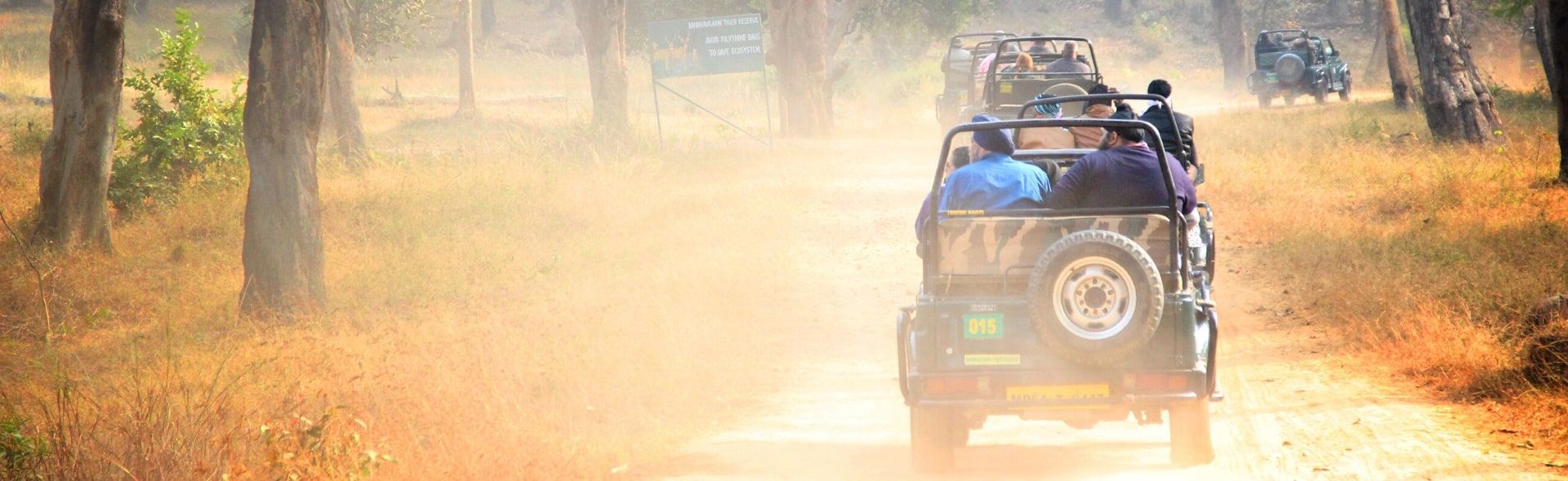 A tour begins with Jeeps driving on a dry and dusty road