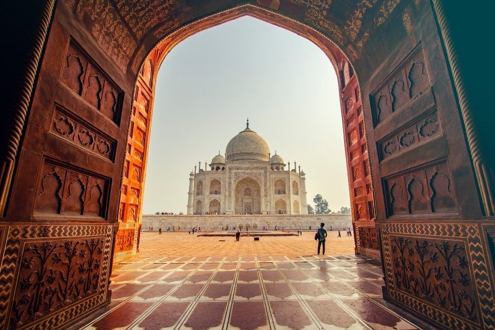 Large orange archway leading to the Taj Mahal