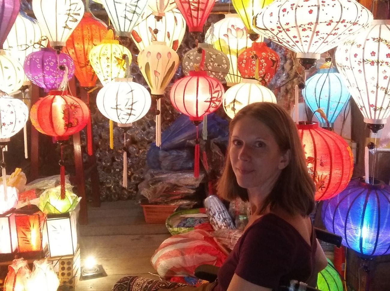 woman in front of bright colourful lanterns